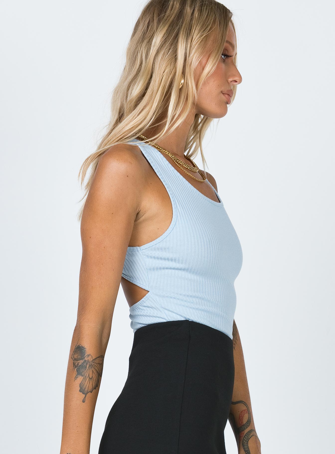 side view of model wearing Princess Polly Atticus Bodysuit Blue Sleeveless Scoop Neck 