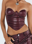 Bustier Faux leather material Inner silicone strip at bust Wired cups Zip fastening at back Pleats at side Pointed hem