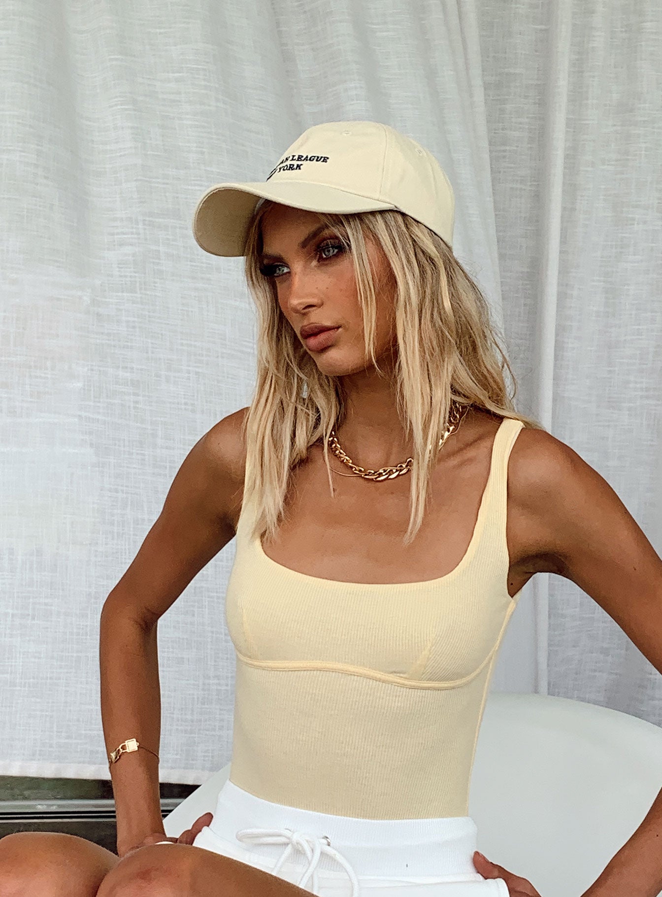 side view of model wearing Princess Polly Crosby Bodysuit Yellow Sleeveless Scoop Neck 