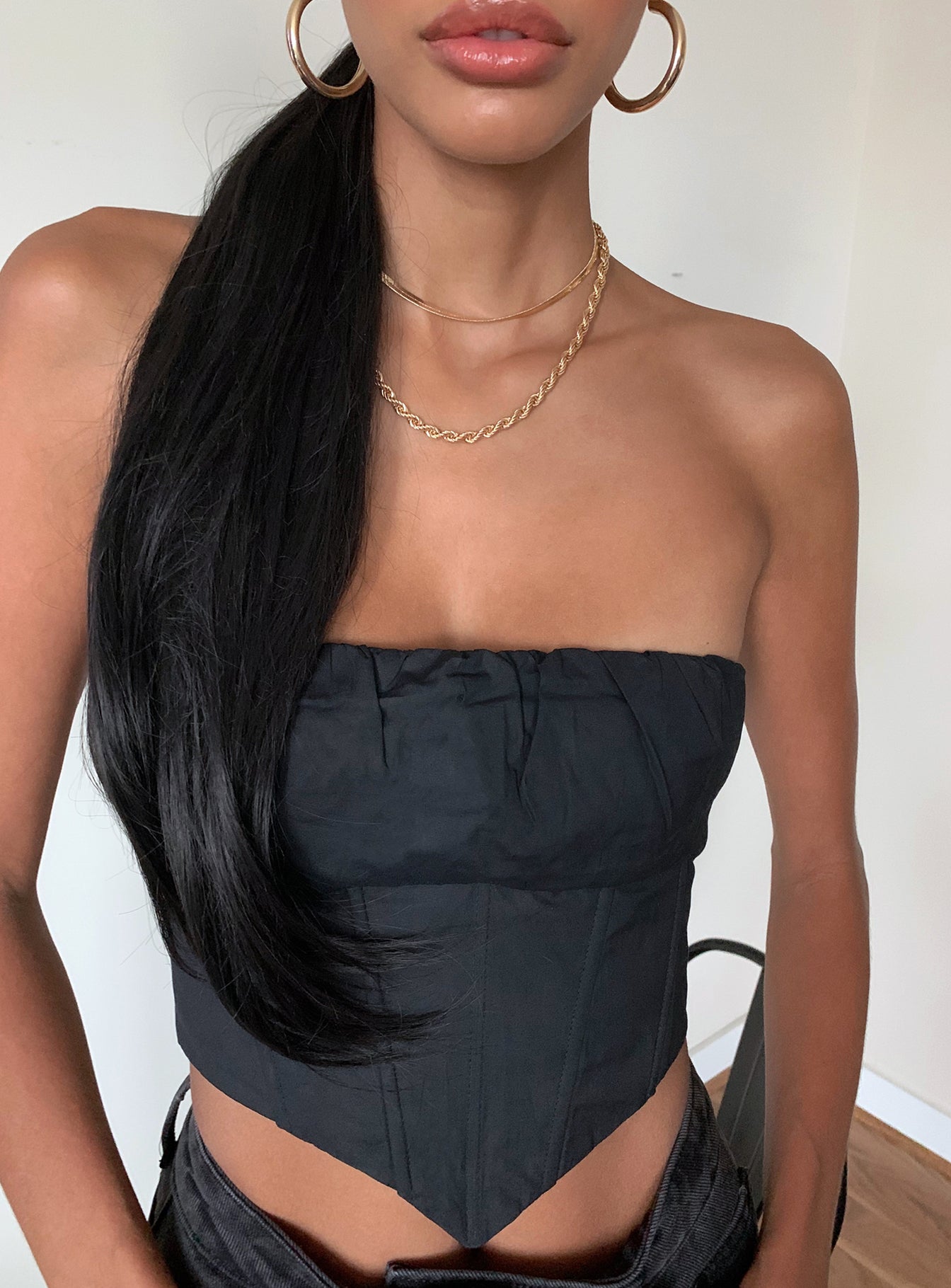 Front view of model wearing  front Princess Polly Sleeveless Asymmetric Neckline  Ivy Bustier Black