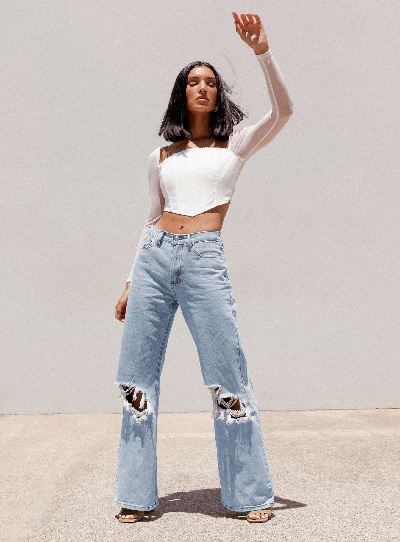 front view of model wearing Princess Polly Maple Flare Jeans Knee Rips Light Wash Denim Mid Rise 