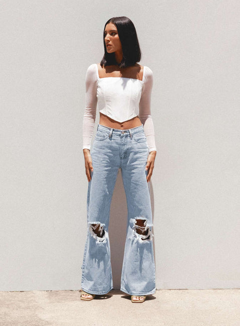 back view of model wearing Princess Polly Maple Flare Jeans Knee Rips Light Wash Denim Mid Rise 