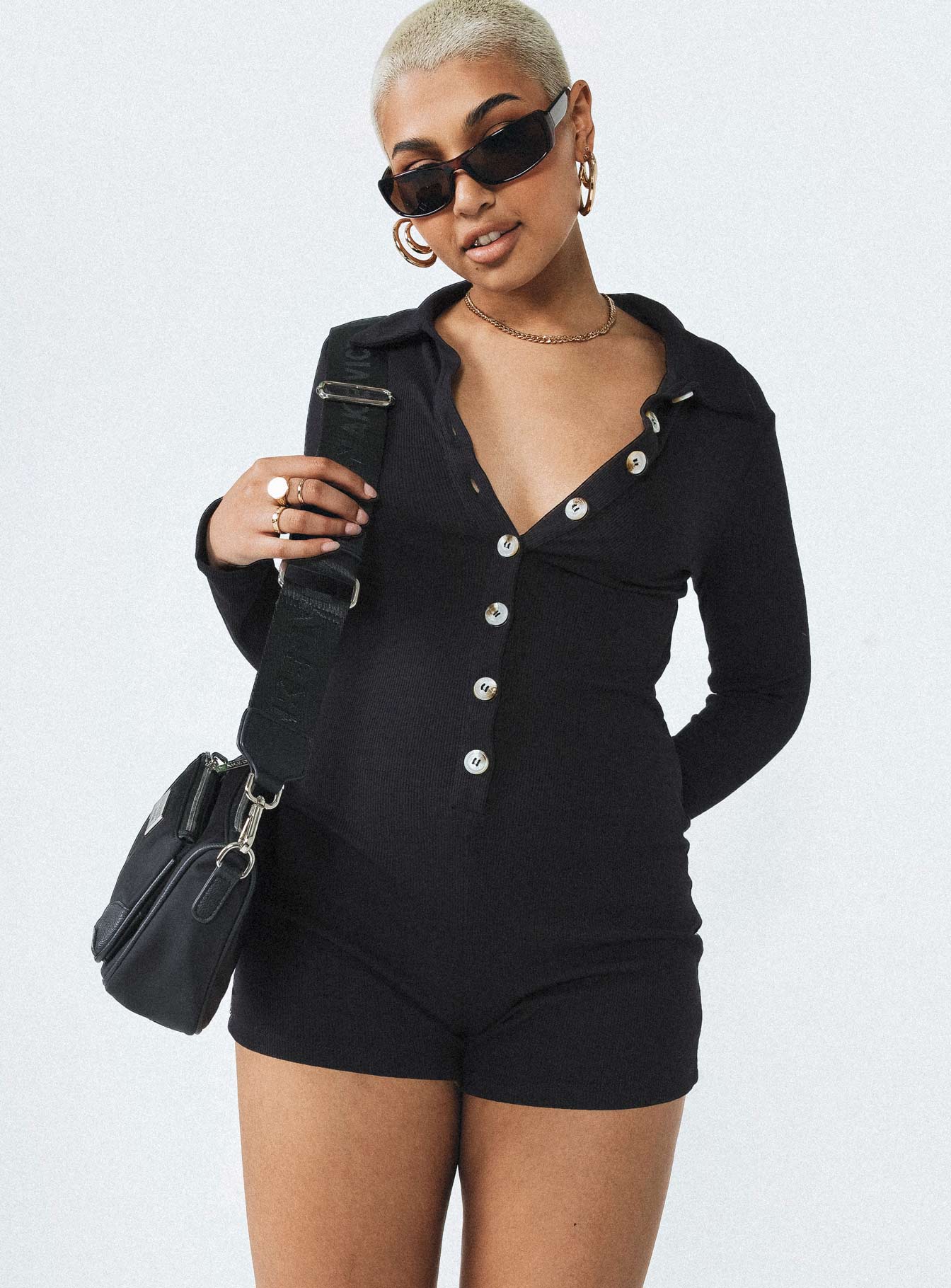 Black playsuit Ribbed material Classic collar Button front fastening Good stretch